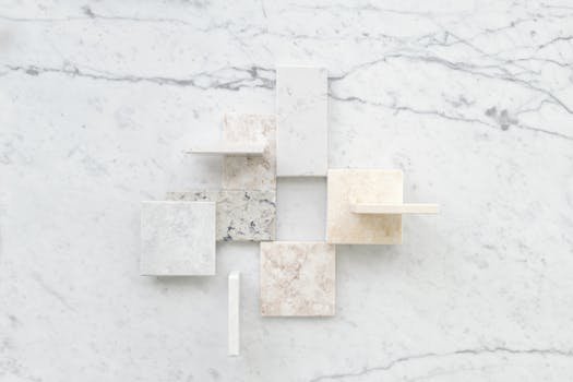 Aerial view of assorted marble tiles arranged on a marble surface showcasing textures.